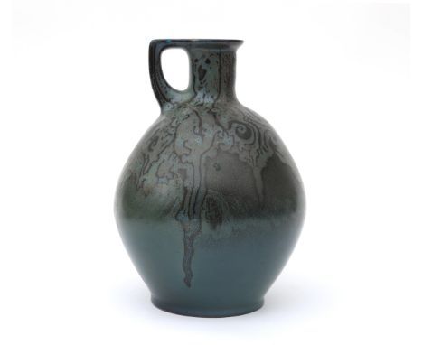 Kunstaardewerkfabriek St. Lukas, Utrecht A ceramic pitcher with handle, decorated with lustre glazed pattern on green ground,