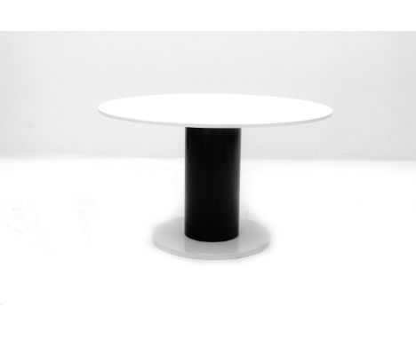 Eighties A circular dining table, white Carrara marble top on cylindrical black lacquered metal on wooden column, with marble