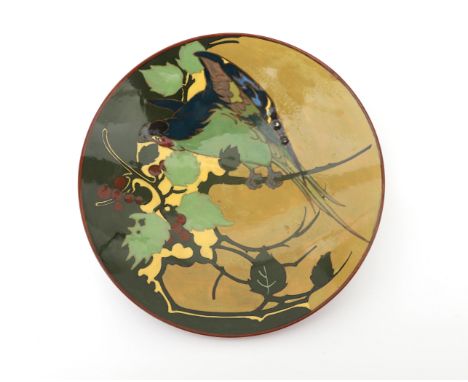 N.V. Haagsche Plateelfabriek Rozenburg, Den Haag (1883-1917) A glazed ceramic wall plate decorated with a bird on a branch, p