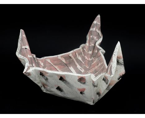 Carol McNicoll (1943) A triangular dish, shaped out of plaques of clay, painted and glazed, circa 1980-1982, signed underneat