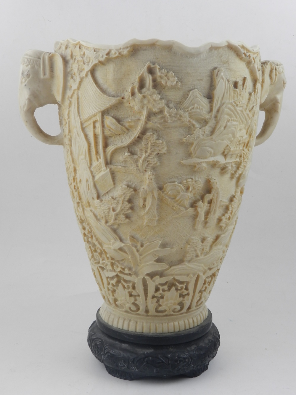 A 20th century Chinese resin vase, having twin-handles and carved with ...