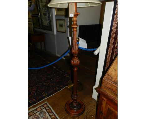 A 20th century carved standard lamp.