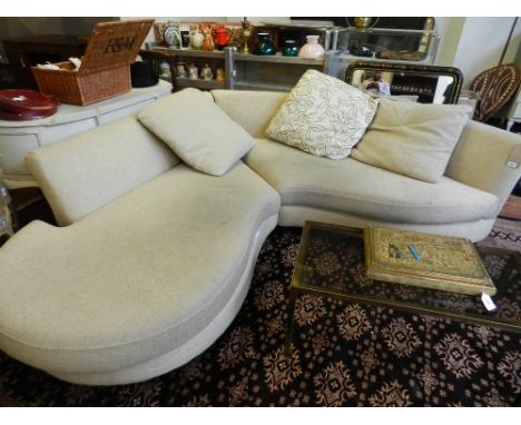 A Contemporary corner sofa, upholstered in a cream fabric.