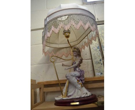 Italian lamp modelled as a lady playing a harp with beaded shade