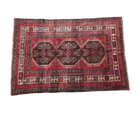 Kars Rug North East Anatolia, circa 1920 The raspberry field with a latch hook panel of cruciform motifs enclosed by ivory Ha