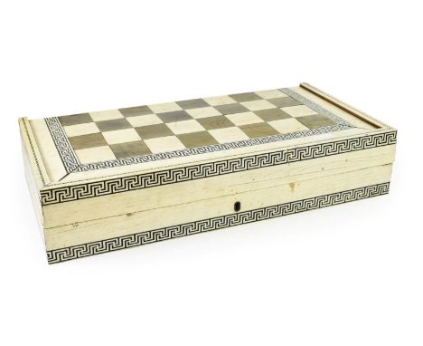 ~ A Vizagapatam Stained and Natural Ivory and Parquetry Games Box, mid 19th century, of hinged rectangular form, the exterior