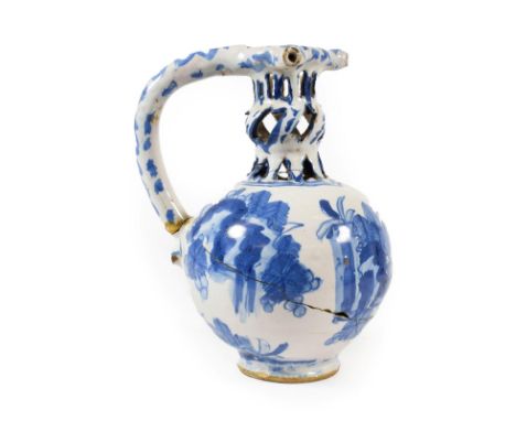 A Dated English Delft Puzzle Jug, London or Brislington, 1670, of ovoid form, the knopped pierced neck with three spouts and 