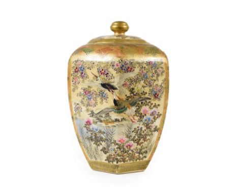 A Satsuma Earthenware Jar and Cover, Meiji period, of hexagonal baluster form, painted with three panels of birds amongst flo