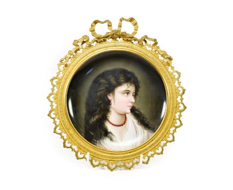 A Vienna Style Porcelain Saucer Dish, circa 1900, painted with a bust portrait of a girl, 19.5cm diameter, mounted in a gilt 