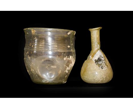 A Roman Glass Beaker, probably 4th century AD, with slightly everted rim and band of three lines and four deep indentations t