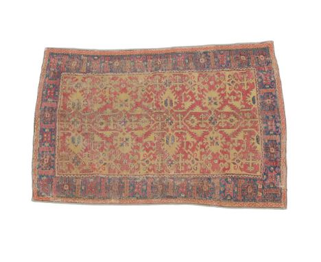 Lotto Rug West Anatolia, 17th century The terracotta field with typical mustard medallions enclosed by a lattice framed by in