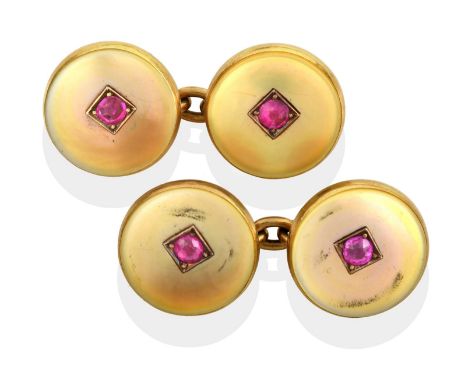 ~ A Pair of Cufflinks, composed of chain linked circular mother-of-pearl plaques with a round cut synthetic ruby centrally.  
