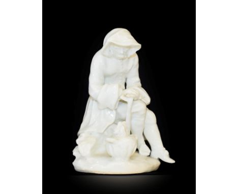 A Bow Porcelain Figure of Winter, circa 1755, from the Rustic Seasons, modelled as a bearded seated figure wearing a hooded c