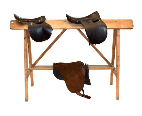 ~ A Pine Saddle Horse, on trestle supports; also, two vintage leather general purpose saddles, a leather and felt racing sadd