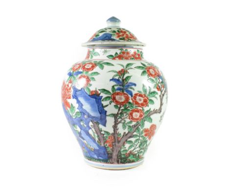 A Chinese Wucai Porcelain Jar and Cover, mid 17th century, of baluster form, painted with birds and insects amongst blossomin