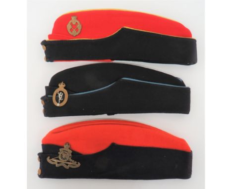Three Corps Coloured Field Service Caps consisting red crown and body. &nbsp;Dark blue curtain. &nbsp;Brass, KC Royal Artille