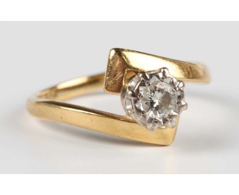 A gold and diamond single stone ring in a twistover design, mounted with a circular cut diamond, detailed “18ct GOLD”, weight