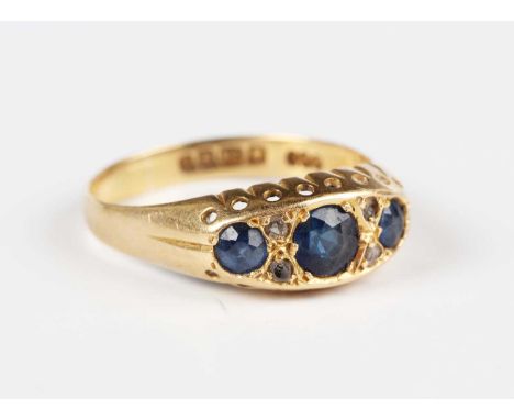 An 18ct gold, sapphire and diamond ring, mounted with three circular cut sapphires and three rose cut diamonds (the fourth ro
