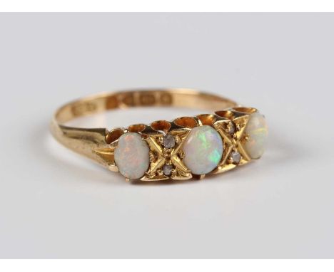 An 18ct gold, opal and diamond ring, mounted with three oval opals and two pairs of diamonds, Chester 1911, weight 3g, ring s