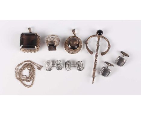 A group of mostly silver jewellery, comprising two smoky quartz pendants, a smoky quartz ring, a silver brooch in a Celtic in