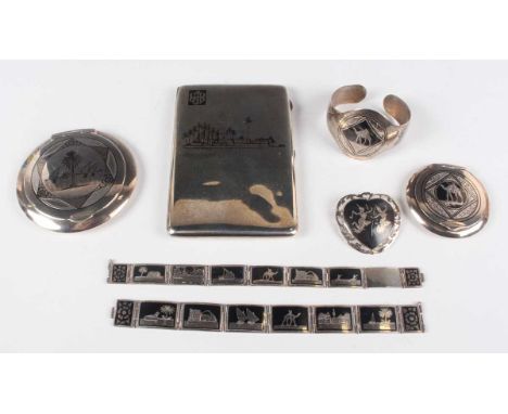 A group of silver and niello ware, comprising a cigarette case, length 12.5cm, two powder compacts, each interior inset with 