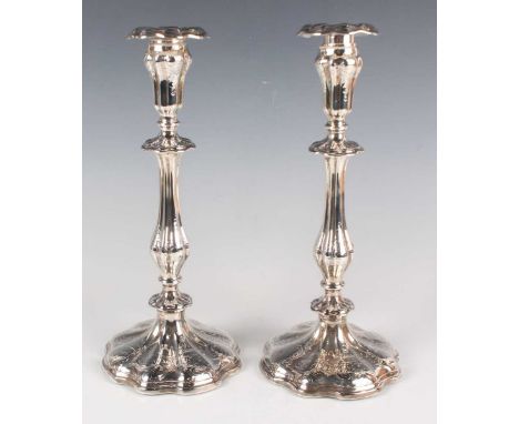 A pair of early Victorian silver candlesticks, each with tapering lobed sconce and circular drip pan above a baluster stem an