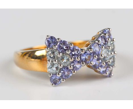 A 9ct gold, pale blue and mauve gem set ring, designed as a tied bow, Birmingham 2006, weight 3.6g, ring size approx R.