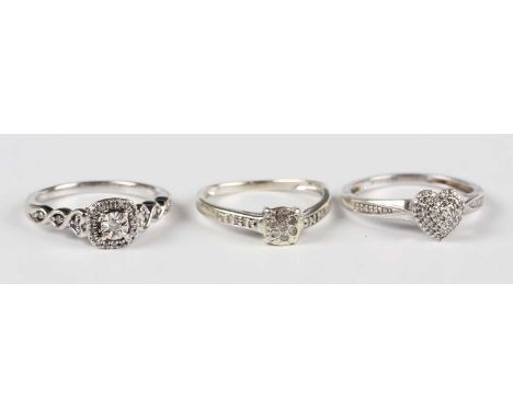 A white gold and diamond cluster ring, detailed '9K', ring size approx K (one shoulder diamond lacking), a 9ct white gold and