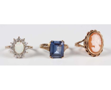 A gold and oval shell cameo ring, carved as a portrait of a lady, detailed ‘9ct’, ring size approx M, a 9ct colour opal and c