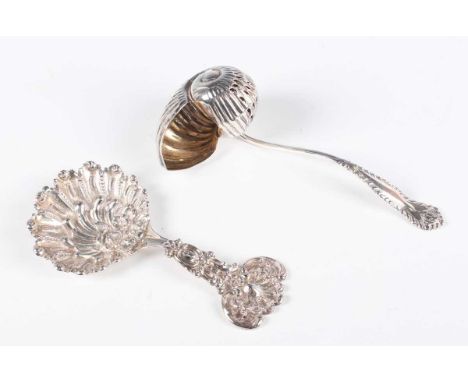 A Tiffany &amp; Co sterling caddy spoon, the cast bowl of stylized scallop shell form with similarly cast tapering handle, mo
