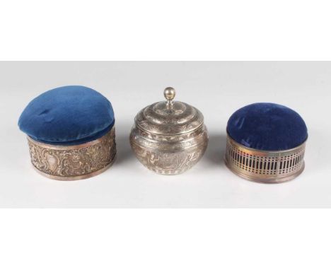 A late Victorian silver circular trinket box, embossed with cherubs and scrolls, London 1895 by William Richard Corke, fitted