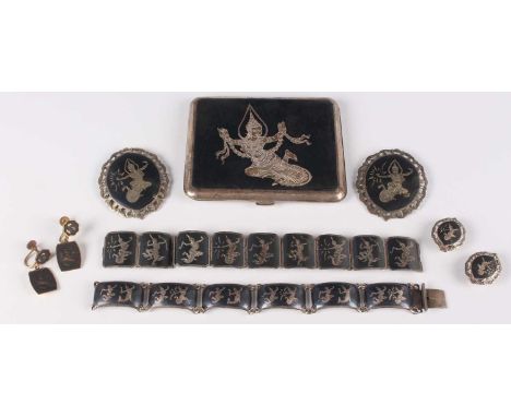 A group of Siamese niello decorated sterling wares, comprising two bracelets, two oval brooches, a pair of earclips and a cig