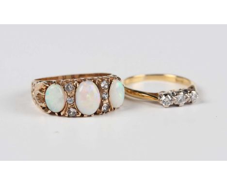 A 9ct gold ring, mounted with three oval opals alternating with two rows of three colourless gems, Birmingham 1975, weight 4.