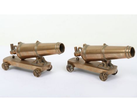 Pair of brass model carronade, late 19th century, tapered barrels 18cm including elevating screw housing, turned reinforces a