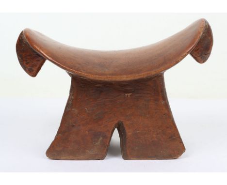 African carved wooden tribal head rest, 20cm tall, rounded ‘saddle-shaped’ top with a pair of downwards pointing projections,