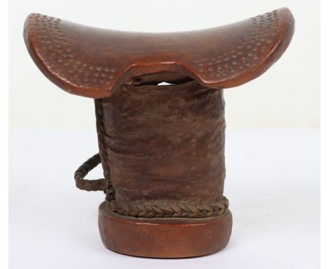 African carved wooden tribal head rest, 17cm tall, rounded ‘saddle-shaped’ top with band of incised dots, leather-covered ste