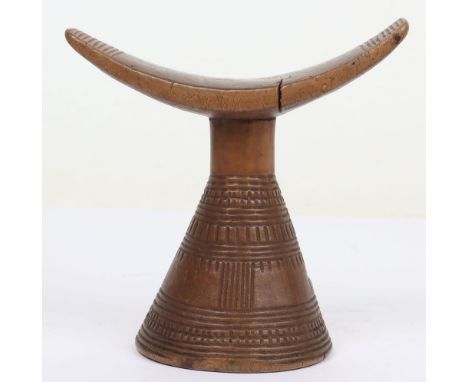 African carved wooden tribal head rest 18.5cm tall, simple cushion-shaped rest on integral conical base. Good condition and g