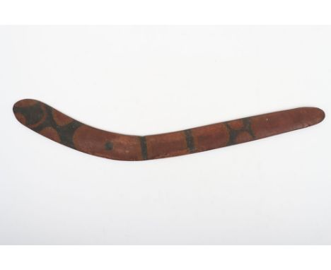 Australian aboriginal carved wooden boomerang, 76.5cm of irregular form, rough finish incorporating incised geometric designs