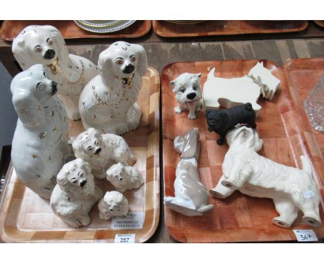 Two trays of dog figurines to include seven variously sized largely Royal Doulton Staffordshire style dogs, with one 19the ce