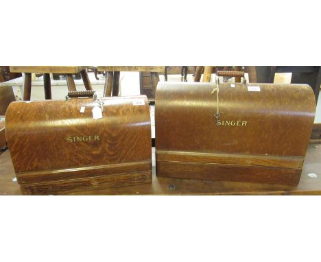 Two similar vintage Singer sewing machines in oak bentwood cases and carrying handles. (2)(B.P. 21% + VAT) 