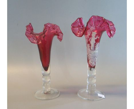 Victorian cranberry glass Mary Gregory style fluted epergne vase with a young girl playing the horn, together with another Vi