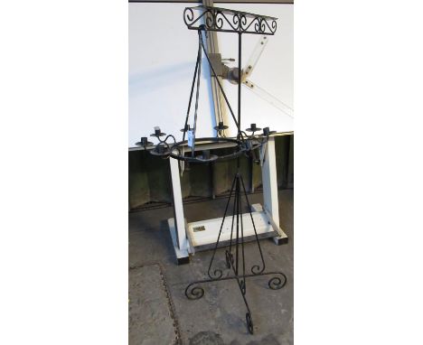 Wrought metal candle light chandelier, together with a wrought metal scroll work stand. (2)(B.P. 21% + VAT) 