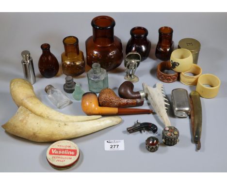 Vintage tin of various oddments to include pipes, Bovril bottles, animal horns, study of a coracle man, napkin rings, etc.(B.