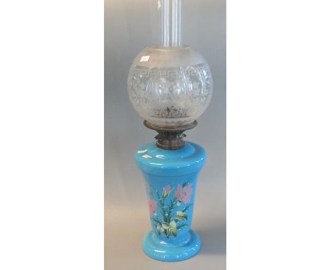 Early 20th century double oil burner lamp with etched globular shade, above a blue opaline glass reservoir, hand painted with