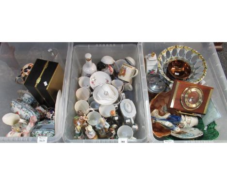 Three boxes of assorted china to include china parrots, figurines, two mantel clocks, empty Bell's Scotch Whisky Bell, commem