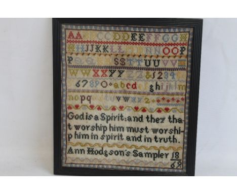 A FRAMED AND GLAZED ANTIQUE SAMPLER BEARING THE NAME ANN HODGSON'S 1869