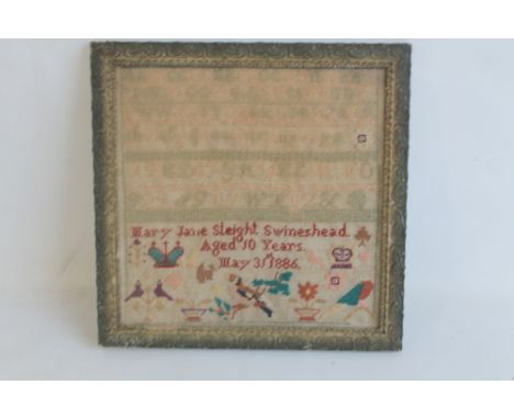 A 19TH CENTURY SAMPLER in multi-coloured threads depicting birds, crown and flowers, named and dated "Mary Jane Sleight, Swin