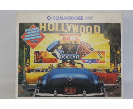 A BOXED COMMODORE 64C CONSOLE, to include cassettes, Top Gun, Great Escape, Rambo etc