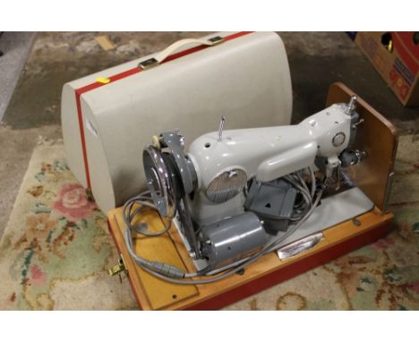 A CASED VINTAGE SEWING MACHINE