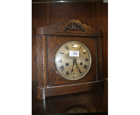 A VINTAGE OAK MANTLE CLOCK